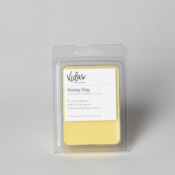 Vidas Sunny Day wax melt packaging on a gray background